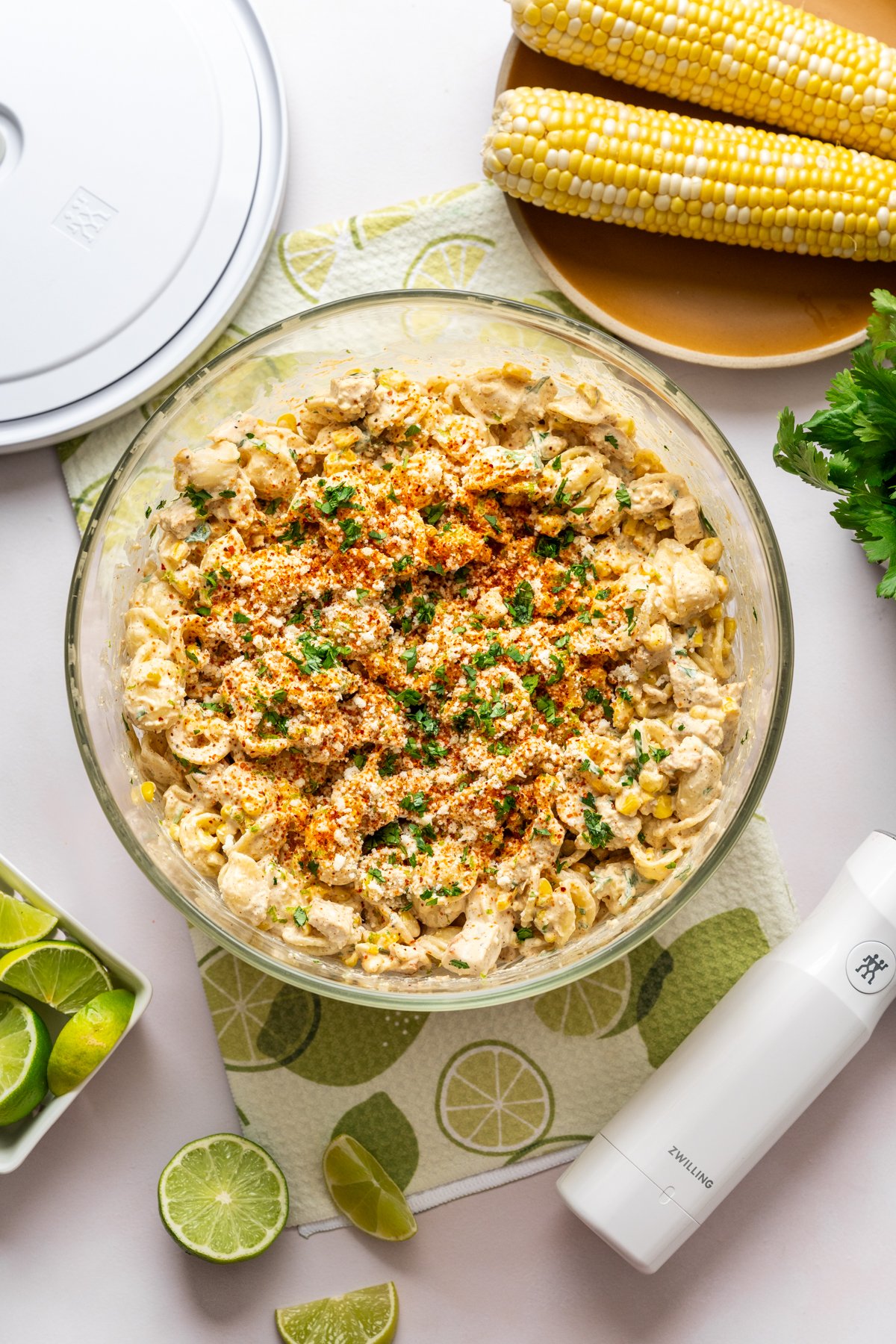 Vue aérienne de la salade de pâtes en élote avec poulet grillé dans un grand bol en verre. 

