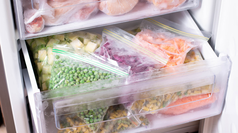 Sacs de légumes surgelés dans le tiroir du congélateur.