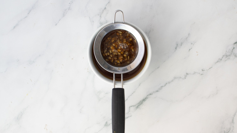 passoire posée au-dessus d'un bol blanc