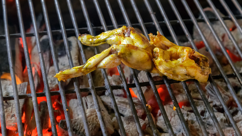 Cuisses de grenouilles grillées sur un gril à charbon de bois
