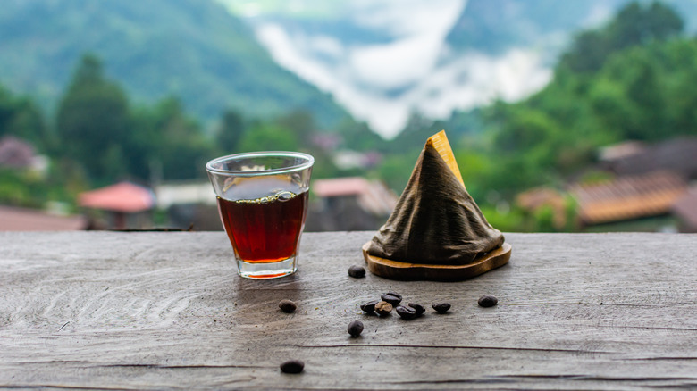 Café et grains de café surplombant une chaîne de montagnes