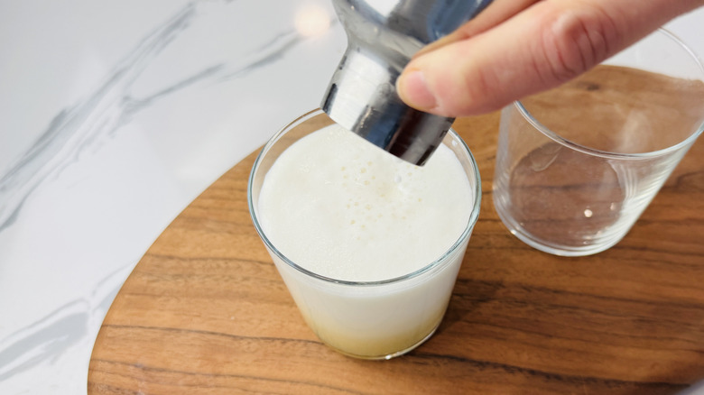 Verser du whisky sour avec de la mousse de blanc d'œuf