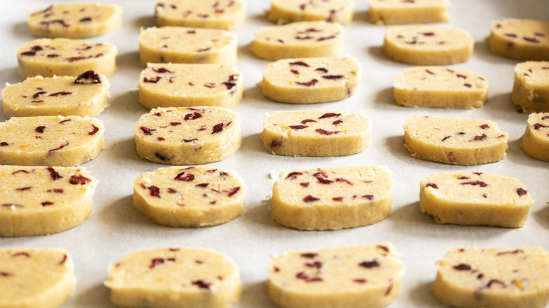Plateau avec des rangées de biscuits crus tranchés et cuits au four