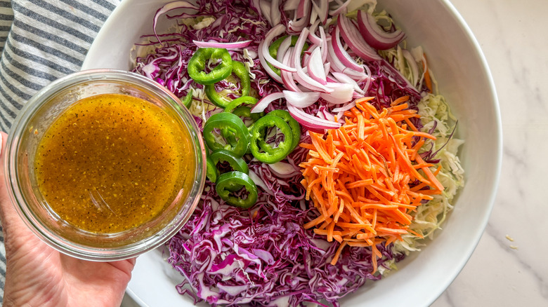 main, ajouter la vinaigrette à la salade