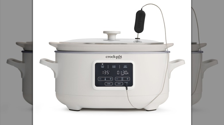 Un large Crock-Pot blanc avec une sonde de température sur le dessus