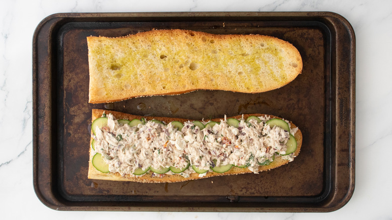 Une salade de thon étagée sur une grosse baguette grillée