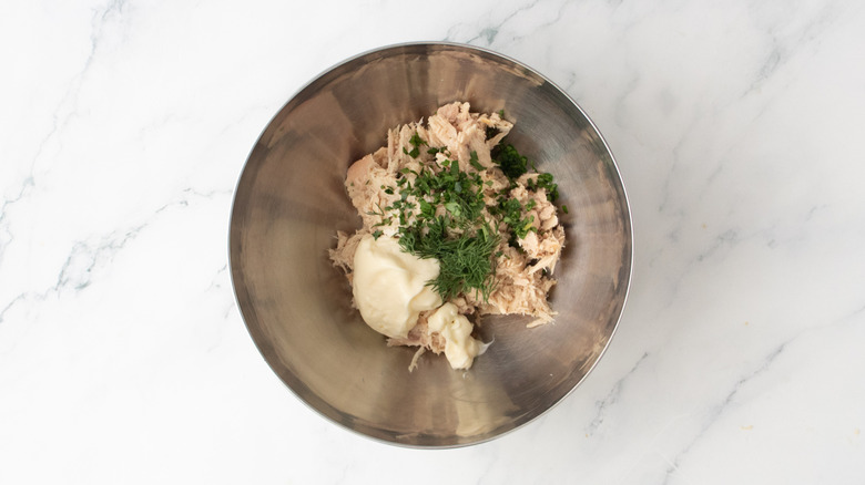 Thon dans un bol en métal avec mayonnaise et assaisonnements
