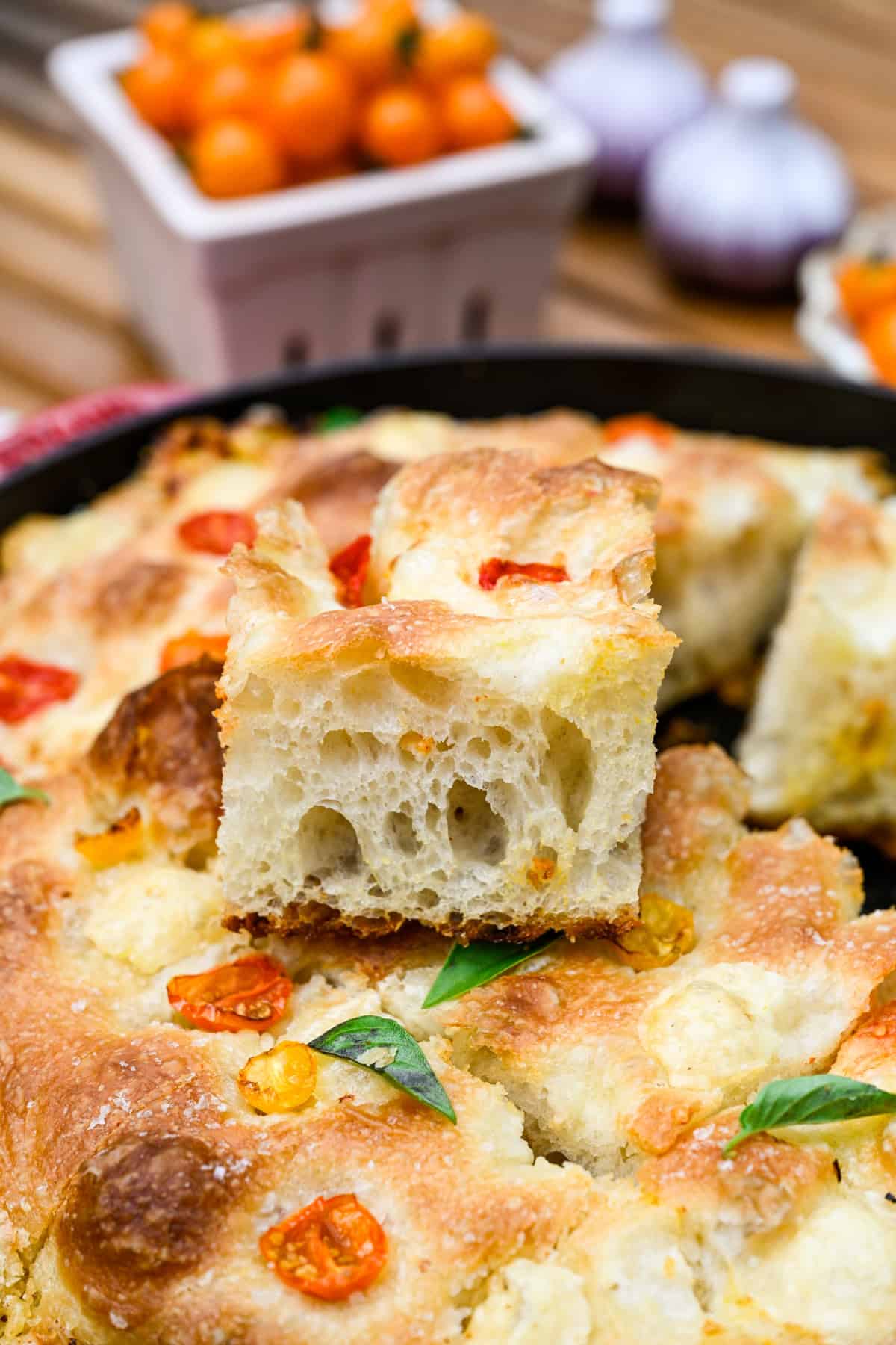 Une tranche de focaccia tomate basilic sur le reste du pain.