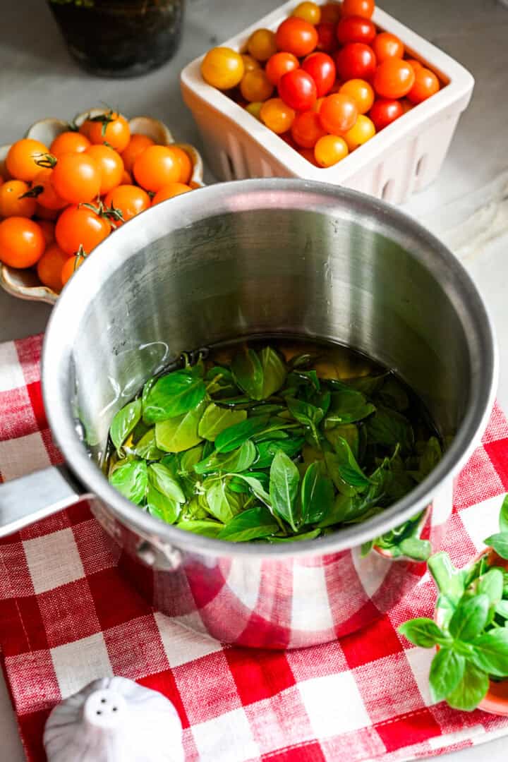 Basilic frais infusé dans l'huile d'olive dans une casserole.