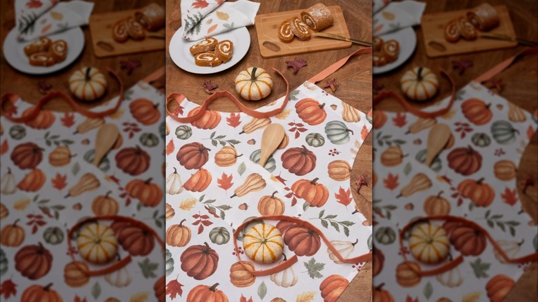 Un nouveau tablier de récolte d'automne de Target décoré de couleurs saisonnières et d'un imprimé citrouille.