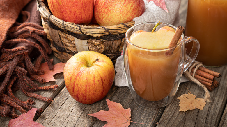 Une tasse de cidre de pomme au caramel dans un tableau automnal.